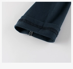 Detailed view of professional stitching on the dark blue knit cuff of a children's t-shirt