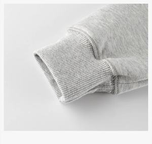 Detailed close-up of ribbed cuffs on heather grey fleece sweatshirt for kids