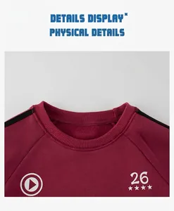 Close-up of burgundy crew neck sweatshirt featuring white 26 star print and rib knit collar