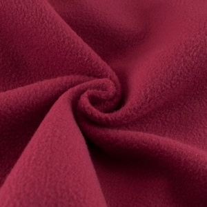 Close-up of soft burgundy fleece fabric with warm texture for boys' hooded sweatshirt