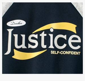 Close-up of Justice print and fabric detail on navy raglan sleeve sweatshirt