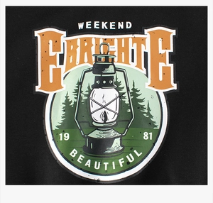 Close-up of retro camping lantern print on black fleece sweatshirt with text details