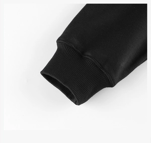 Close-up of elastic ribbed cuff on children's black fleece sweatshirt with detailed stitching