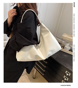 Detail of white leather hobo bag with wrinkled texture and silver zipper for women
