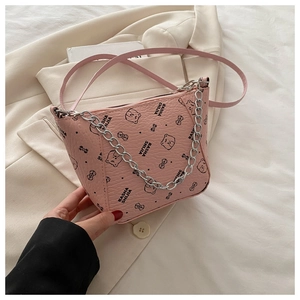 Detail of pink bucket bag featuring litchi grain texture and cute cartoon bear print