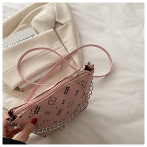 Pink bucket bag with cartoon bear print and silver metal chain detail in flat lay view