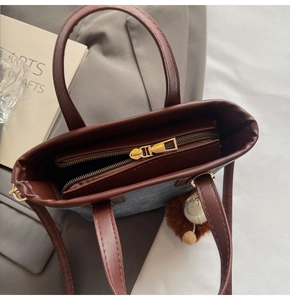 Internal view of dark brown leather tote bag with zipper closure and spacious compartments