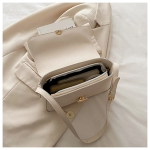 Interior view of beige crossbody bag showing storage capacity for phone and wallet