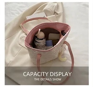 Detail view of large tote interior showing capacity for umbrella and cosmetics