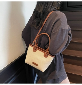 Details der Canvas-Beuteltasche mit braunem Lederbesatz und verstellbarem Schultergurt