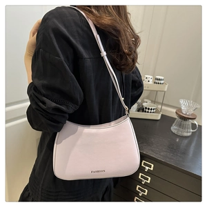 Détail du sac à bandoulière en cuir PU lilas montrant le texte FASHION et la sangle réglable