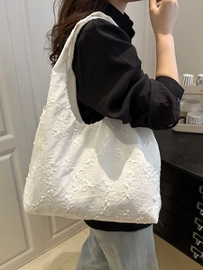 Minimalist white canvas tote bag with floral embroidery for daily commute and leisure