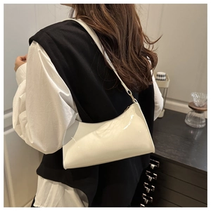 Chic white patent leather baguette bag shown as a stylish underarm shoulder bag accessory