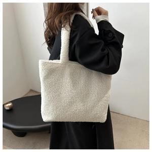 Detailed texture of white plush tote bag shown with a minimalist lifestyle background