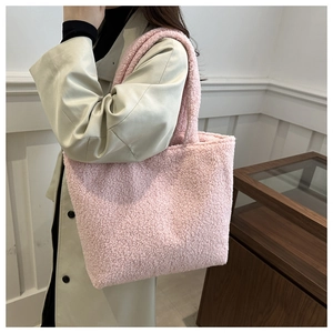 Detailed texture of pink plush tote bag showing soft fuzzy lamb wool fabric surface