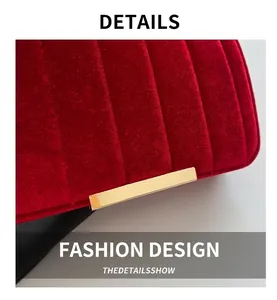 Macro view of red velvet quilting texture and polished gold metal buckle on a shoulder bag