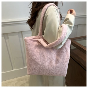 Detailed view of a plush pink faux fur tote bag showing texture and winter style carry