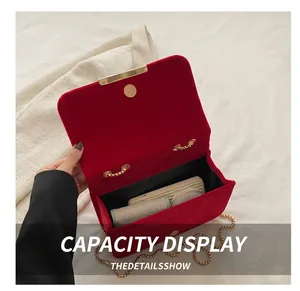 Interior view of red velvet chain bag showing storage capacity for daily essentials