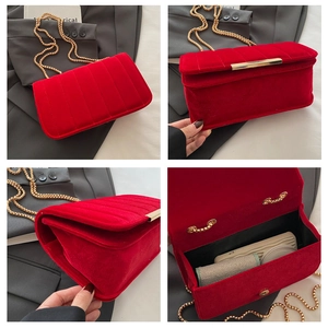 Detail view showing red velvet chain bag interior capacity and vertical embossed pattern