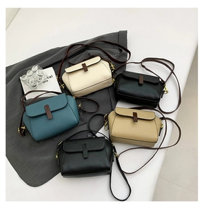 Close-up of retro crossbody bags in white, black, green and khaki with lychee texture
