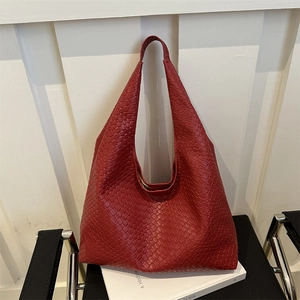 Red woven hobo shoulder bag with classic textured pattern on a minimalist background