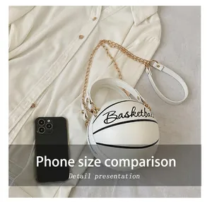 Size comparison of white basketball-shaped chain purse next to a smartphone