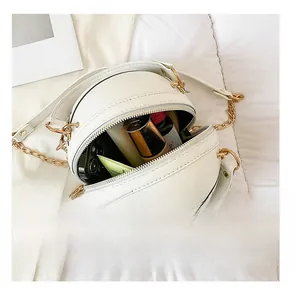 Interior view showing capacity of white basketball-shaped chain cross-body bag