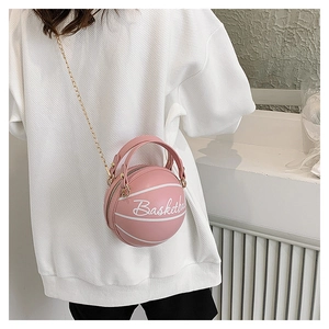Detail of creative pink basketball shaped crossbody bag with gold chain and top handle