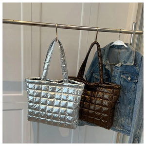 Quilted tote bags in metallic silver and dark brown finish with square padded texture