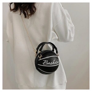 Detail of creative basketball-shaped crossbody bag with gold chain and leather texture