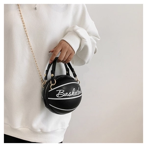 Detail of creative basketball-shaped crossbody bag with gold chain and white script lettering