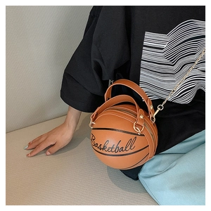 Detail of creative brown basketball-shaped shoulder bag with golden chain strap