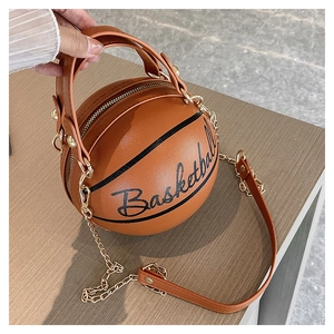 Macro view of basketball shaped purse featuring gold chain strap and side logo text
