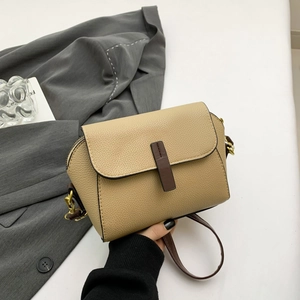 Khaki pebbled leather crossbody bag with dark brown trim and golden metal hardware
