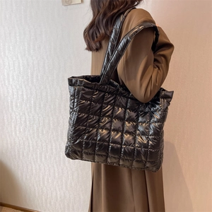 Quilted black puffer tote bag in glossy nylon fabric, oversized crossbody shoulder handbag
