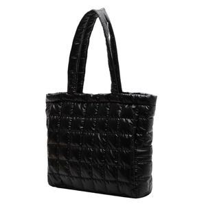 Glossy black quilted puffer tote bag with padded double handles for women in urban style