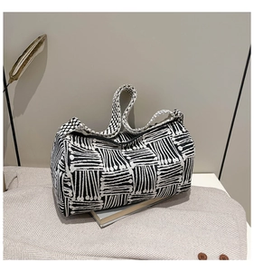 Detail of black and white geometric woven pattern on a stylish Boston style handbag