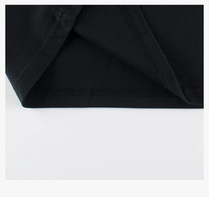 Détail de l'ourlet à double aiguille sur un t-shirt noir à manches longues pour enfant