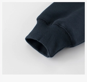 Detailed close-up of dark blue ribbed elastic cuffs on a thick fleece children sweater