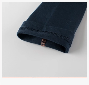 Close-up of boys' blue cotton tee with contrast orange interior stitching detail