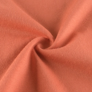 Detailed macro view of the soft brick red knit fabric texture for boys long sleeve tee