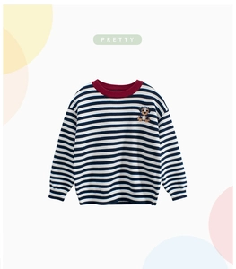 Detailed view of child's striped knit sweater with cute puppy embroidery and red neckline