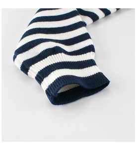 Detail of blue and white striped knit sweater cuff with elastic ribbed texture