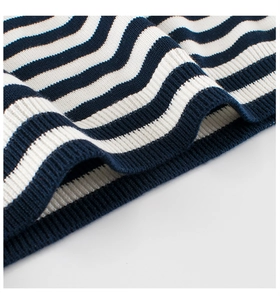 Macro detail of blue and white striped knit fabric with rib-knit texture and soft finish