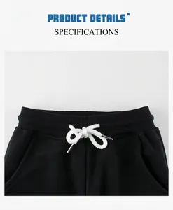 Close-up of black cotton sweatpants waist with elastic ribbing and white drawstring