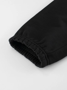 Kids black cotton sports joggers featuring elastic ribbed cuffs for spring comfort