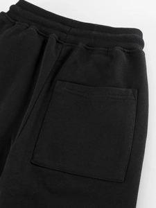 Kids black cotton jogger pants featuring elastic waistband and large back pocket detail