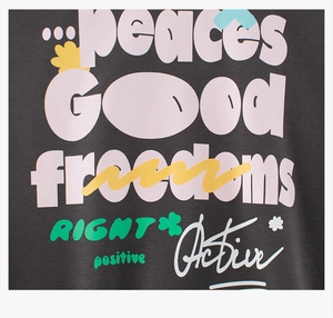 Detail of colorful bubble letter graffiti print on dark grey cotton sweatshirt fabric