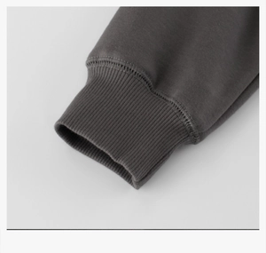Detailed macro view of dark grey ribbed cuffs and high-quality knitted sweatshirt fabric