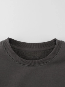 Dark grey crewneck sweatshirt for kids featuring warm fleece lining and ribbed neckline